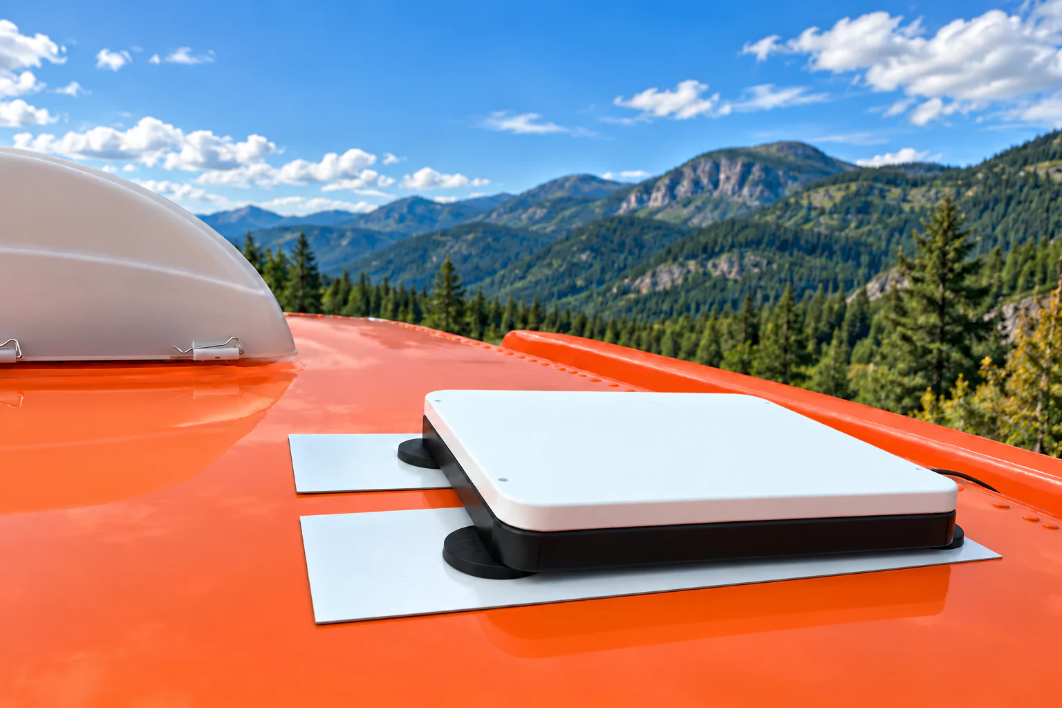 Edited image of a Starlink Mini in a magnetic mount on an orange vehicle roof, with a scenic mountain background